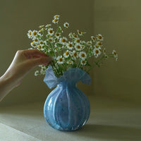 Round-bellied glass vase by TRLab Shop with clear, smooth surface and wide opening, ideal for floral arrangements and decorative displays.