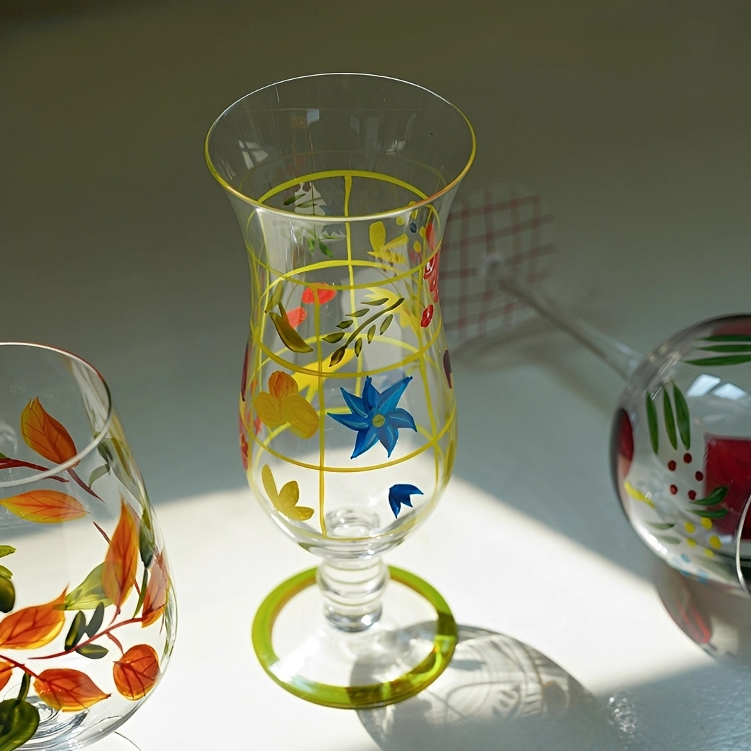 Hand-painted glass vase with colorful floral design, showcasing intricate artwork and a smooth, rounded shape.