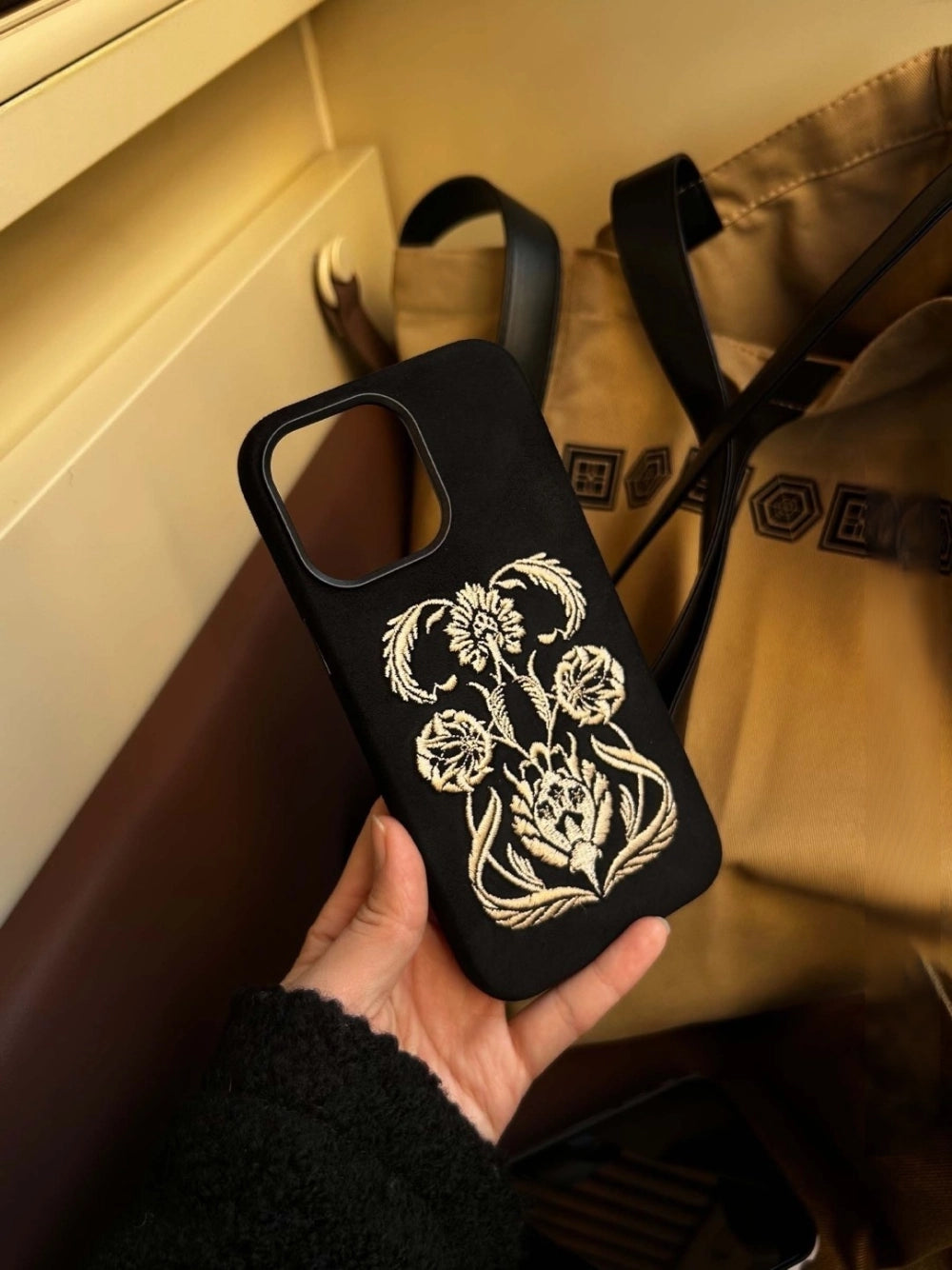 Black shamanic embroidered phone case with intricate tribal designs, made by TRLab Shop for a stylish and protective accessory.