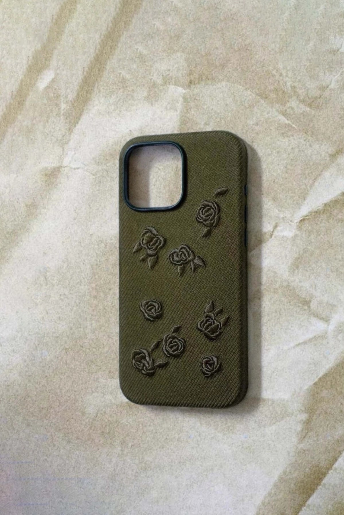 Green phone case with embroidered rose design from TRLab Shop, showcasing detailed floral embroidery on smooth material.