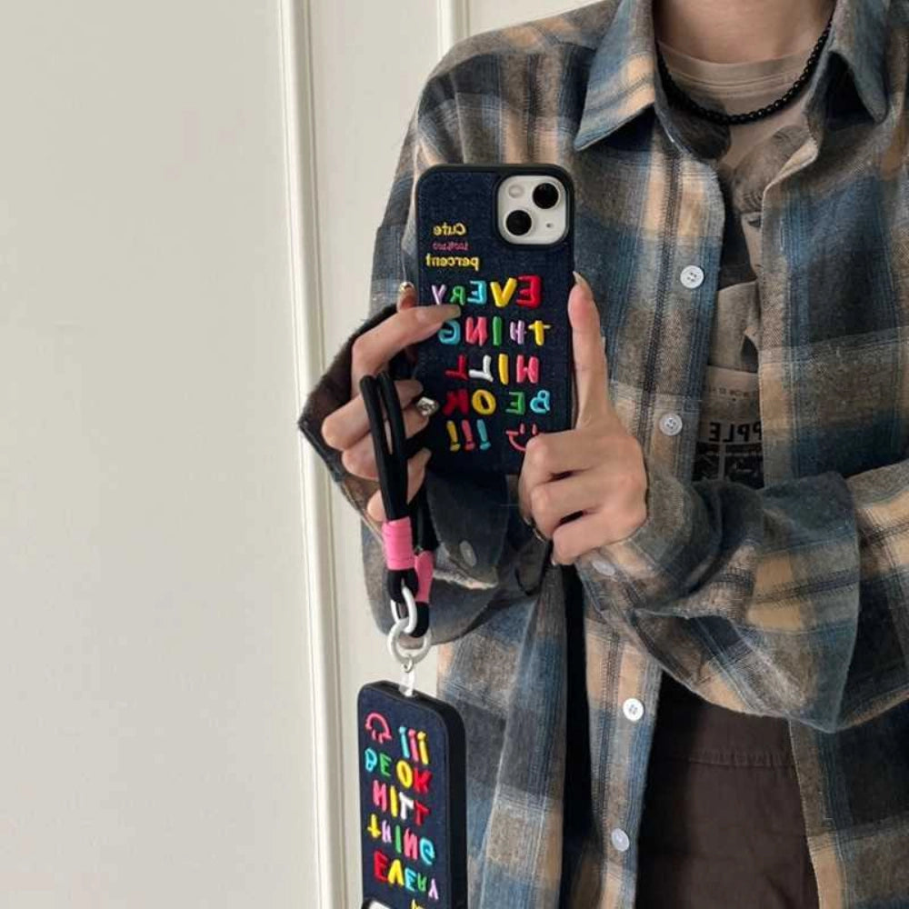Colorful embroidered phone case with letter designs from TRLab Shop, showcasing vibrant fabric and detailed stitching.