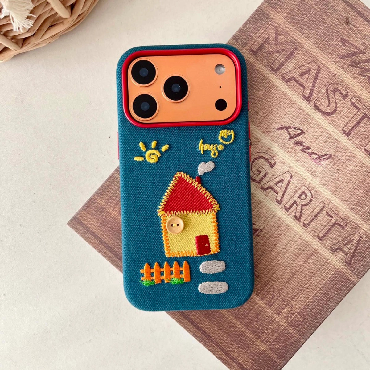 Embroidered house phone case from TRLab Shop with detailed floral embroidery and protective design for smartphones.