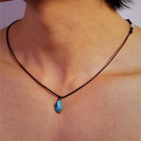 Turquoise hand-woven cord necklace from TRLab Shop featuring intricate craftsmanship and vibrant color.