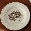 Decorative floral ceramic plate with vibrant flower patterns, designed by TRLab Shop, showcasing intricate botanical artwork on a round plate.