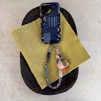 Tie-dyed fabric phone case by TRLab Shop featuring vibrant, colorful tie-dye pattern and soft fabric material for smartphone protection.