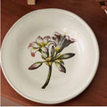 Decorative floral ceramic plate with vibrant flower patterns, designed by TRLab Shop, showcasing intricate botanical artwork on a round plate.