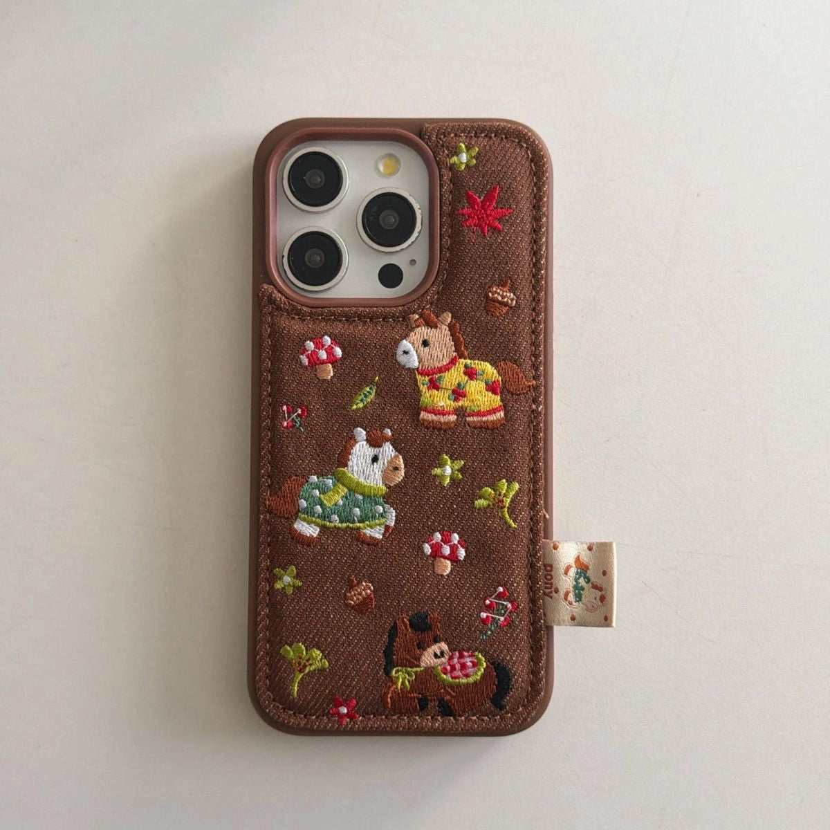 Embroidered pony phone case by TRLab Shop featuring a colorful pony design on a protective phone cover.