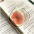 Translucent fruit-shaped acrylic bookmark with colorful fruit illustrations, ideal for marking pages in books.