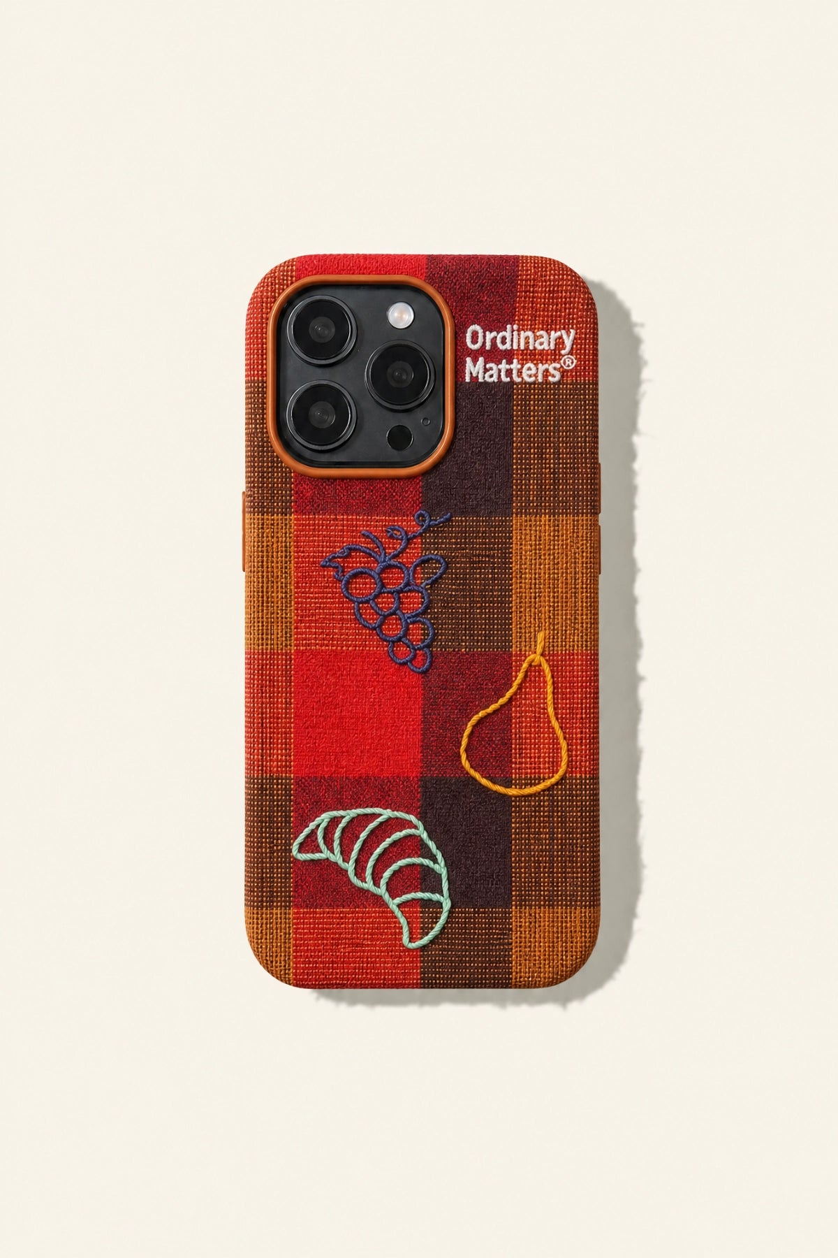 Embroidered phone case with fruit and bread design from TRLab Shop, showcasing colorful fruit and bread motifs on a protective cover.