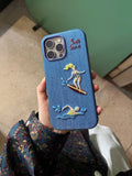 SoftServe Surf & Tennis embroidered MagSafe phone case with colorful embroidered design on a protective case.