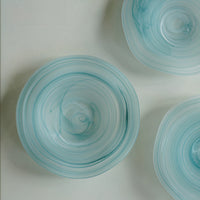 Teal wavy rim glass matte plate with elegant design, perfect for serving dishes or decorative tableware.