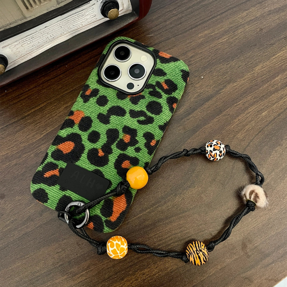 Green leopard print corduroy phone case by TRLab Shop, showing textured fabric and stylish design for smartphones.
