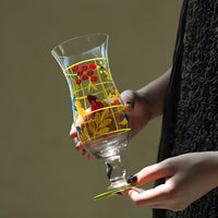 Hand-painted glass vase with intricate floral designs, showcasing vibrant colors and artistic craftsmanship.