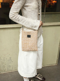 Beaded straw crossbody bag with intricate bead detailing and adjustable strap, perfect for casual and summer outings.
