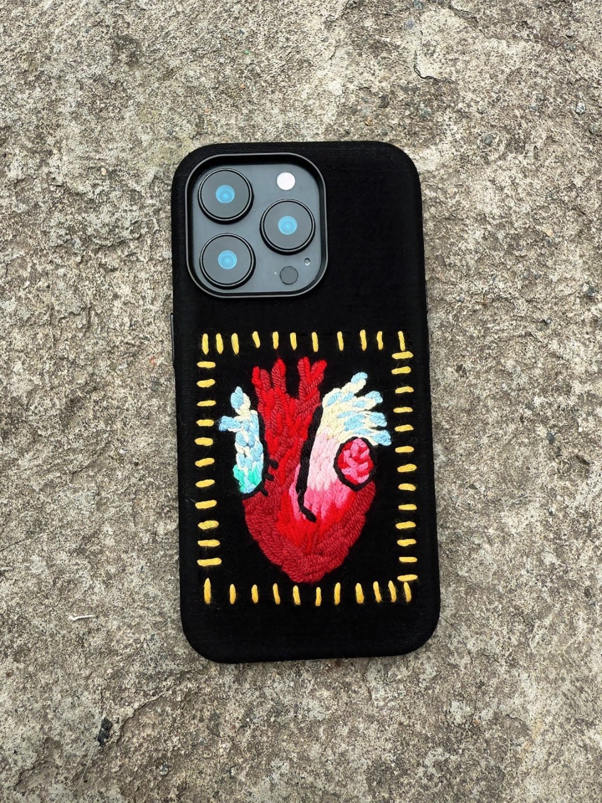 Embroidery heart design on a TRLab Shop phone case with colorful floral embroidery on a sleek, protective accessory.