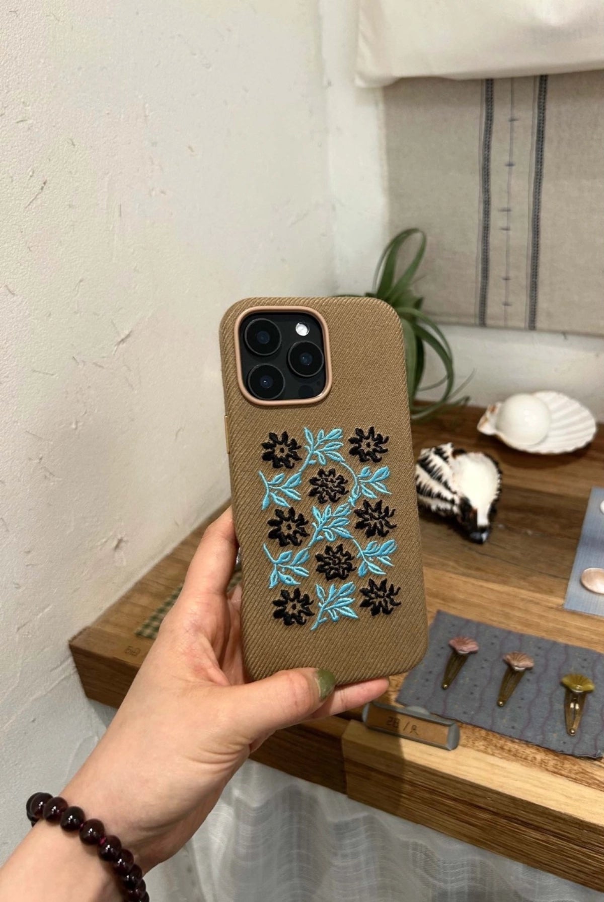 Vine and floral embroidered phone case by TRLab Shop, featuring intricate floral embroidery on a protective case.