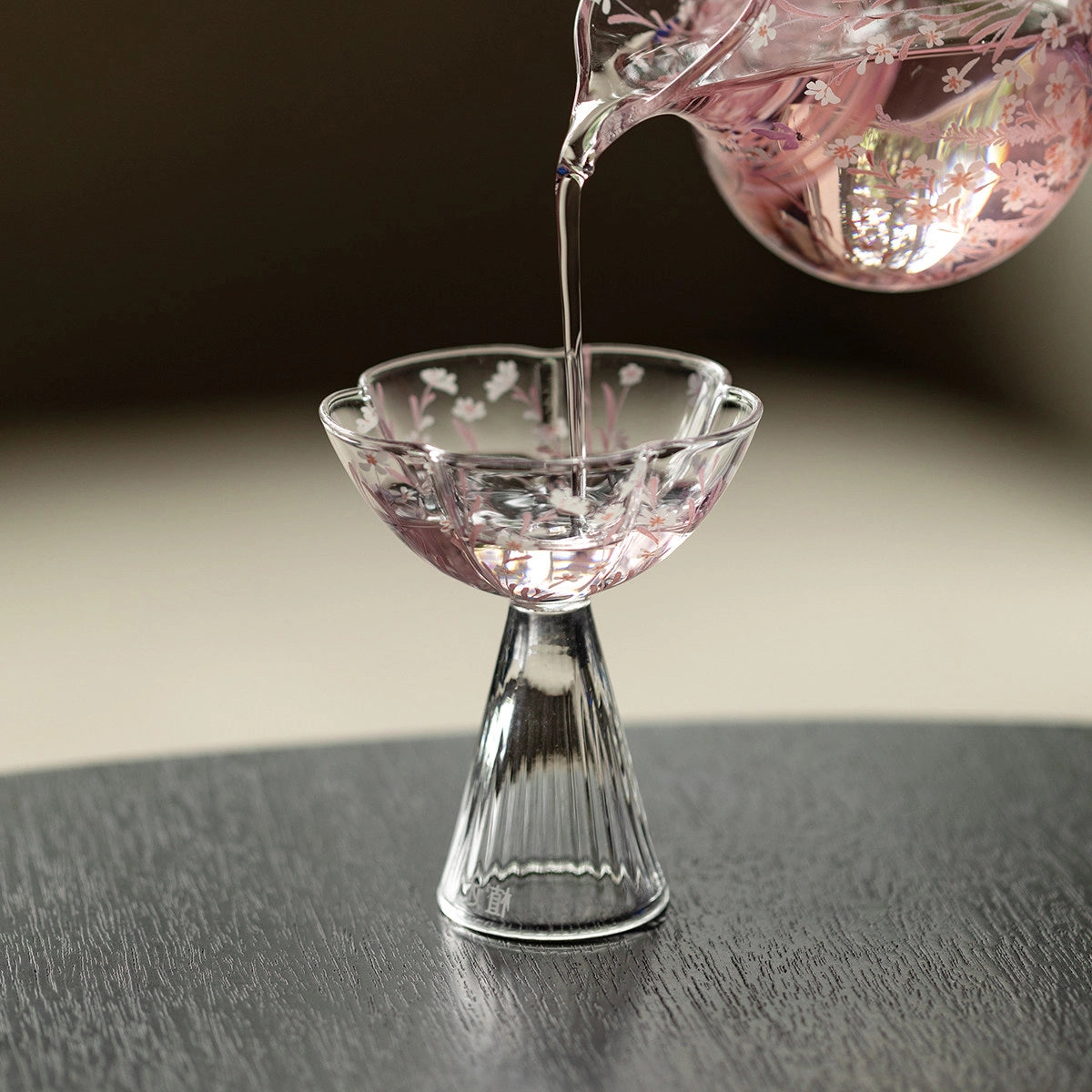 Pink Sakura Blossom glassware from TRLab Shop featuring delicate cherry blossom designs on clear glass for elegant beverage presentation.