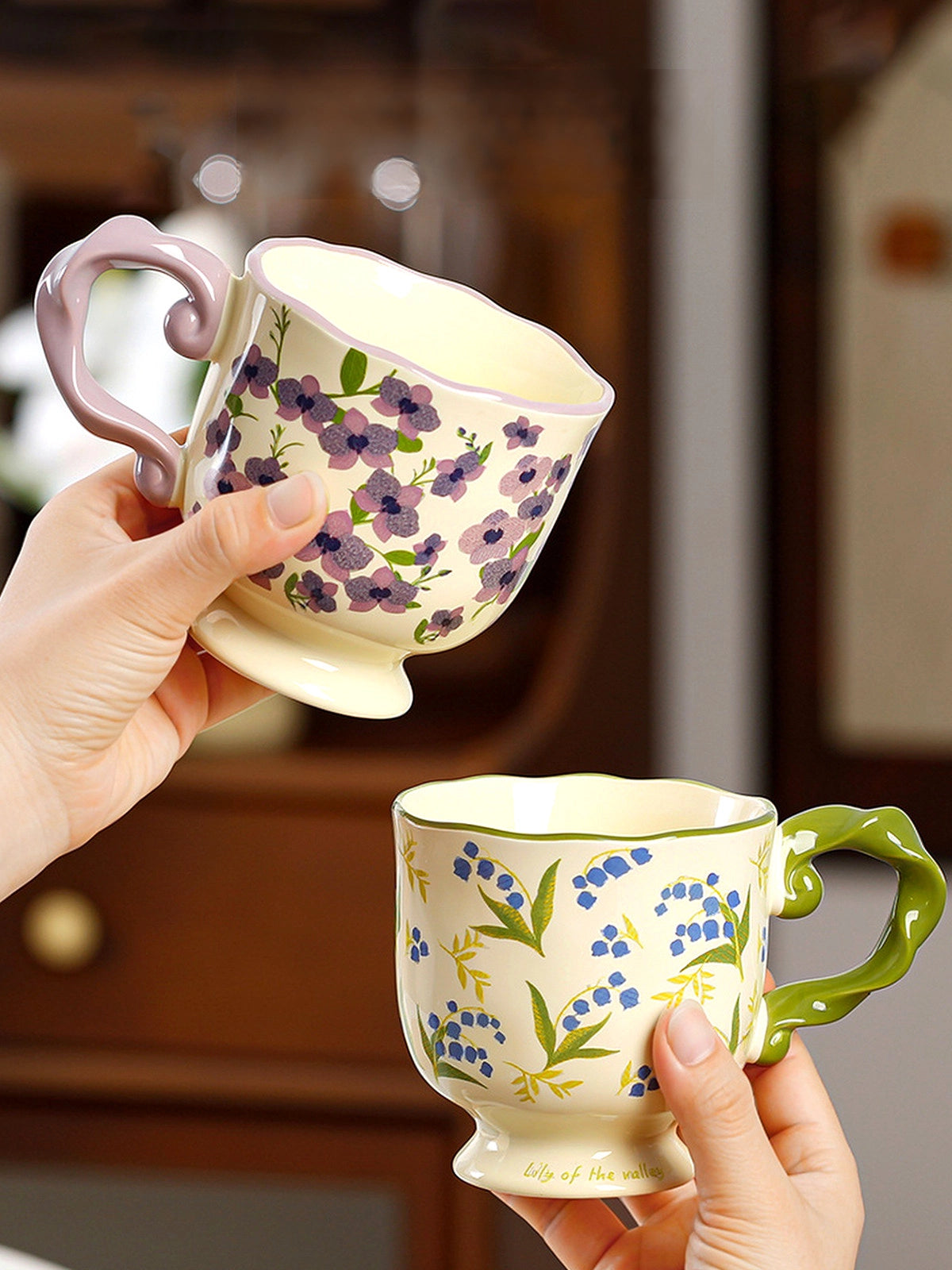 Ceramic mug with floral design and twisted handle by TRLab Shop, featuring colorful floral patterns on a white background.