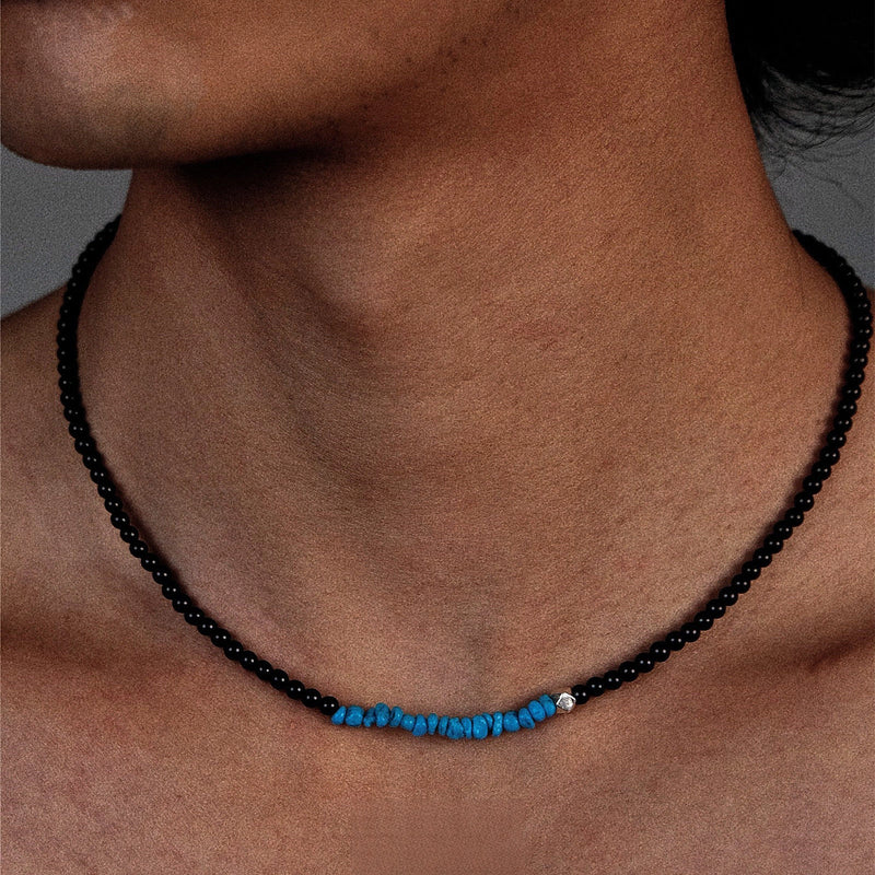 Black onyx and turquoise beaded necklace with a silver clasp, featuring a stylish and elegant design.