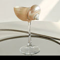 Silver and green conch-shaped wine glass, elegant drinkware by TRLab Shop with intricate conch shell design.