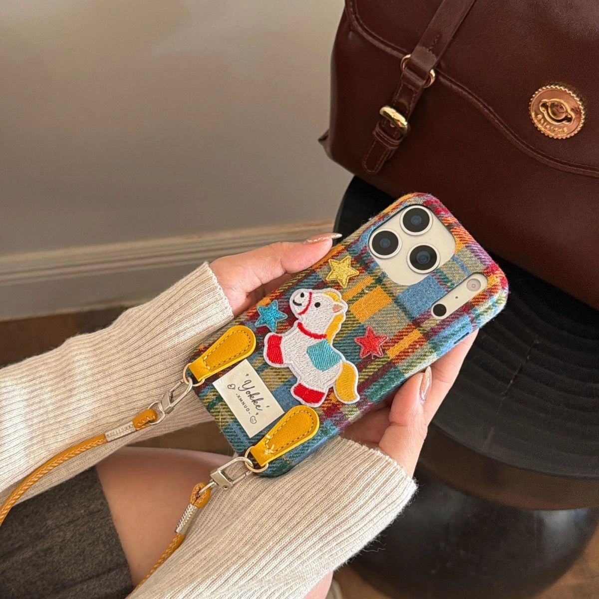 Plaid Pony embroidered phone case by TRLab Shop featuring a colorful plaid pattern and a stitched pony embroidery design.