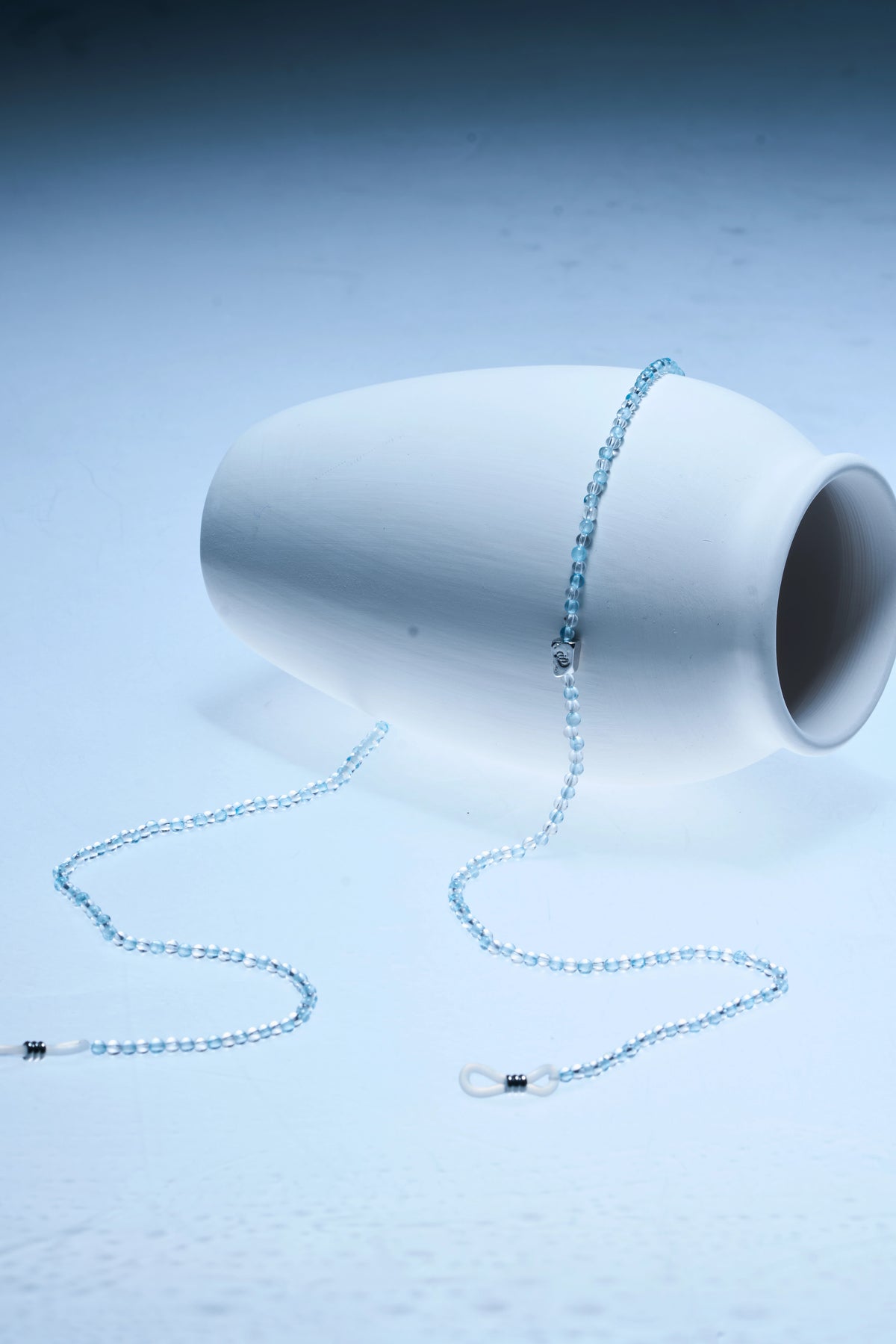 Aquamarine and clear quartz beads on a ROCKBUND eyeglass chain with silver clasp, designed to hold glasses securely.