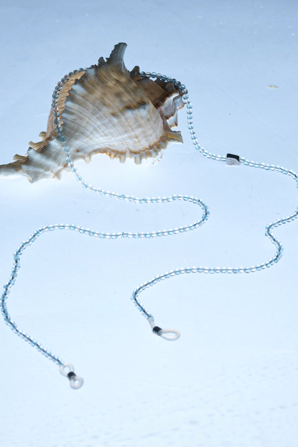 ROCKBUND aquamarine and clear quartz eyeglass chain with decorative beads and clasp, designed to hold eyeglasses securely.