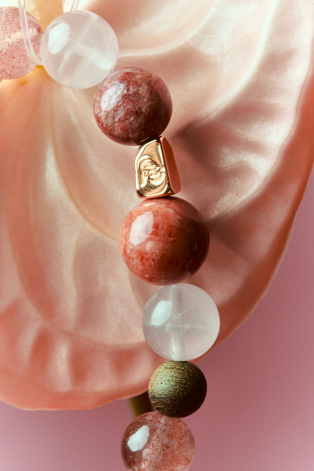 Strawberry Quartz and Red Jasper healing bracelet featuring polished beads, designed by ROCKBUND for wellness and style.