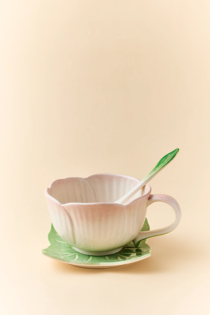 Pink ceramic Begonia cup and saucer set with matching spoon, elegant and decorative for tea or coffee presentation.