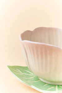 Pink ceramic Begonia cup and saucer set with matching spoon, elegant and decorative for hot beverages.