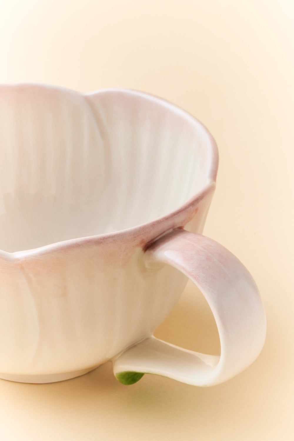 Pink ceramic Begonia cup and saucer set with matching spoon, elegant floral design, perfect for tea or coffee serving.