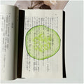 Translucent fruit-shaped acrylic bookmark with colorful fruit illustrations, ideal for marking pages in books.