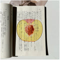 Translucent fruit-shaped acrylic bookmark with colorful fruit illustrations, ideal for marking pages in books.