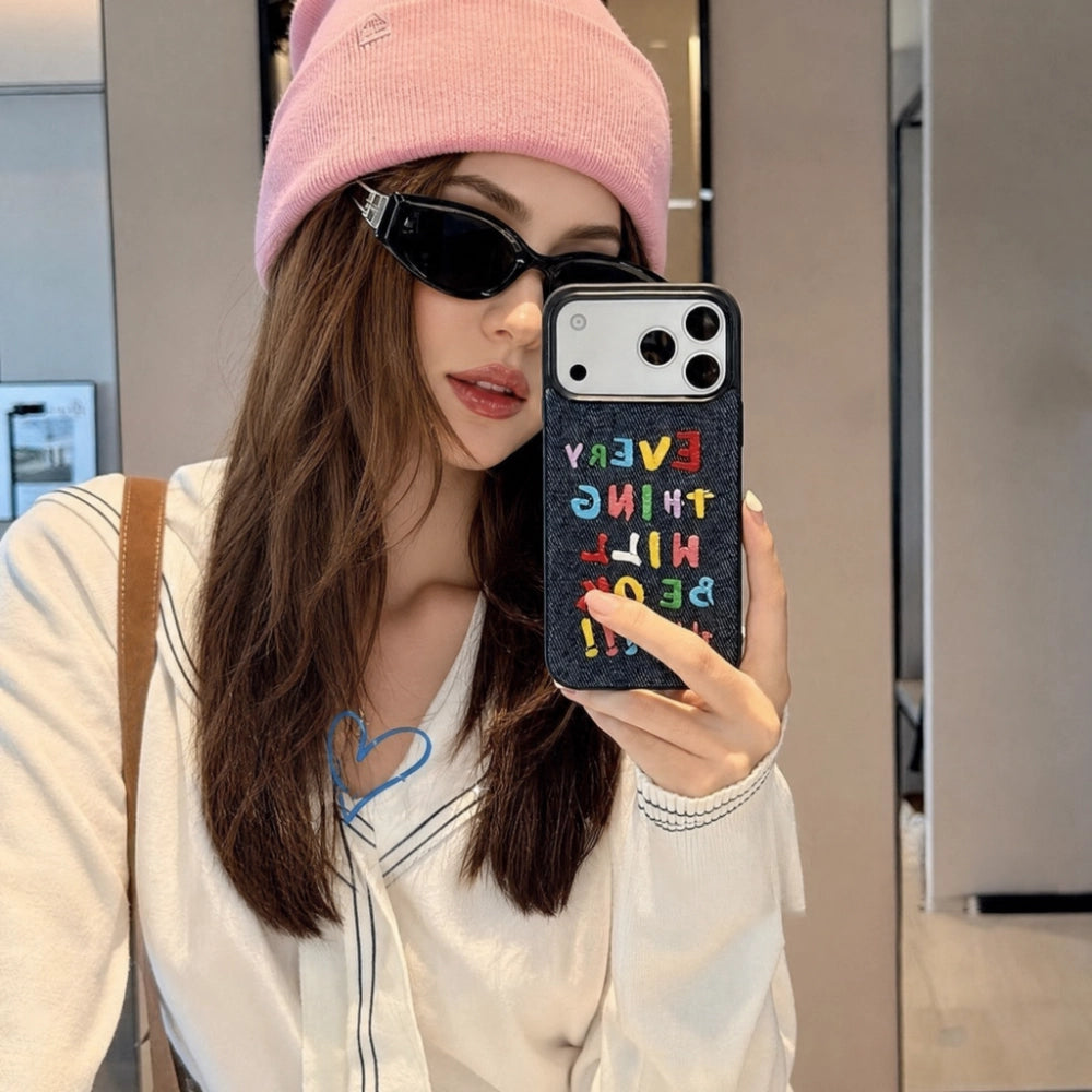 Colorful embroidered letters on a phone case by TRLab Shop, featuring vibrant, decorative embroidery on a protective phone cover.