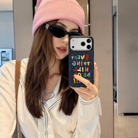 Colorful embroidered letters on a phone case by TRLab Shop, featuring vibrant, decorative embroidery on a protective phone cover.