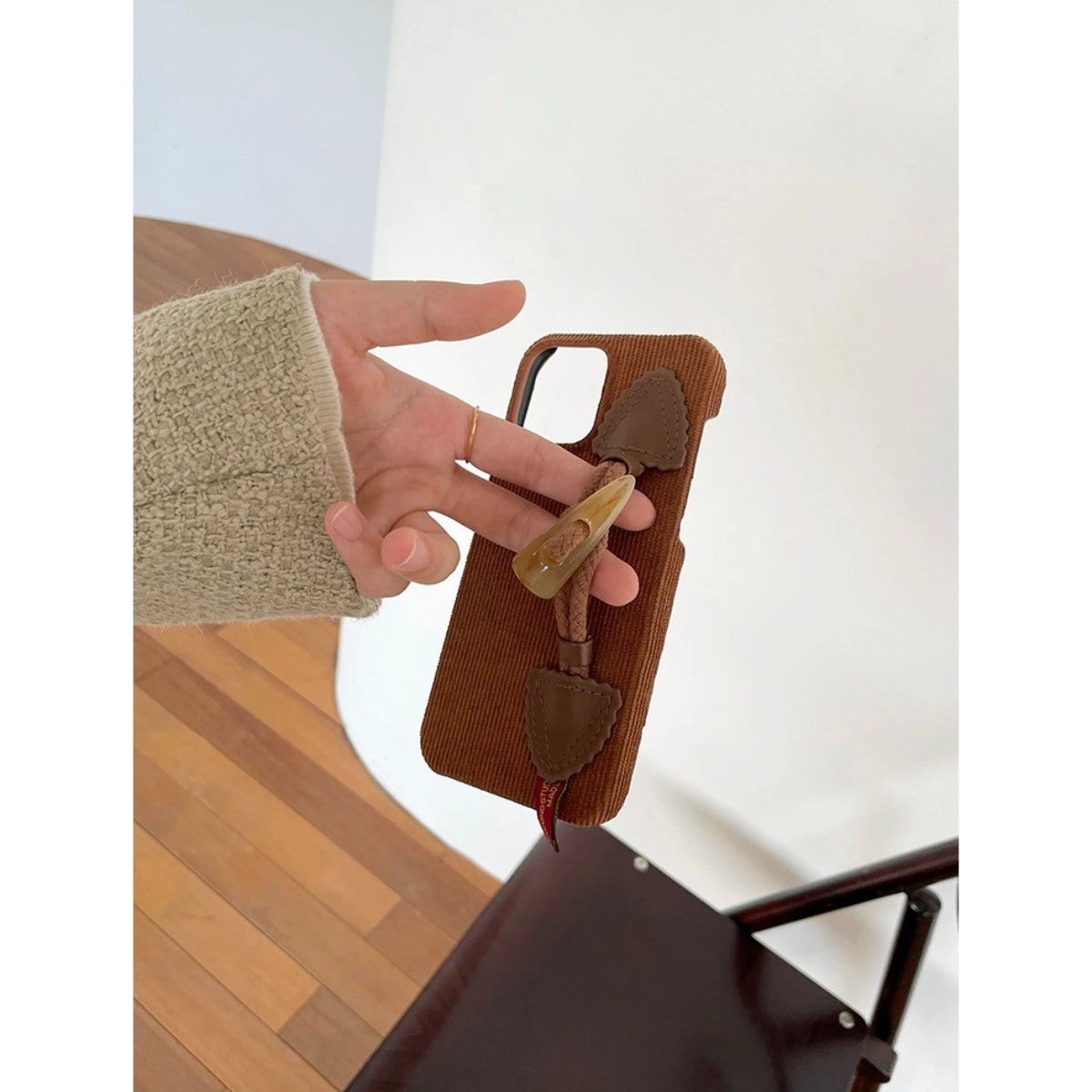 Striped corduroy fabric phone case with toggle button closure, designed by TRLab Shop, featuring a stylish and textured pattern.
