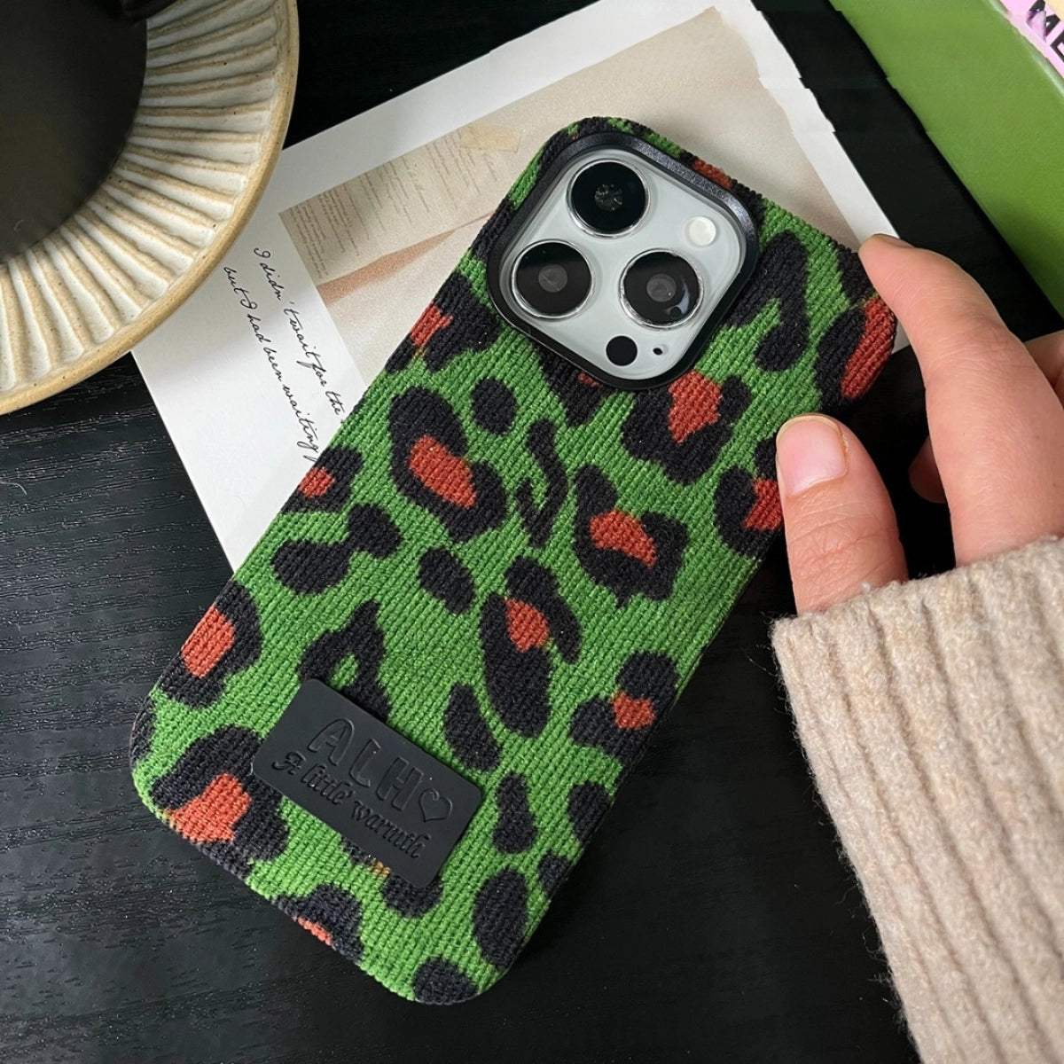 Green leopard print corduroy phone case by TRLab Shop, showing textured fabric and stylish design for a smartphone protection.