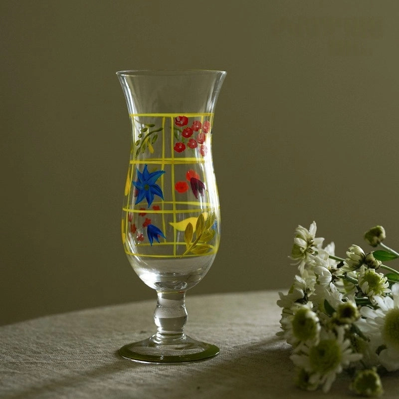 Hand-painted glass vase with floral design, featuring vibrant colors and a curved shape, ideal for decorative display.
