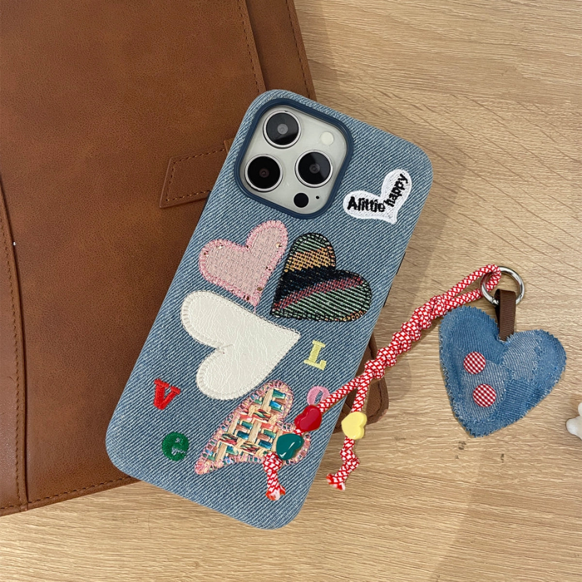 Love Heart embroidered phone case by TRLab Shop featuring colorful heart designs on a protective phone cover.