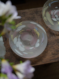 Luminous Fragment Glass Plate by TRLab Shop showing a detailed close-up of iridescent glass fragments on a flat surface.