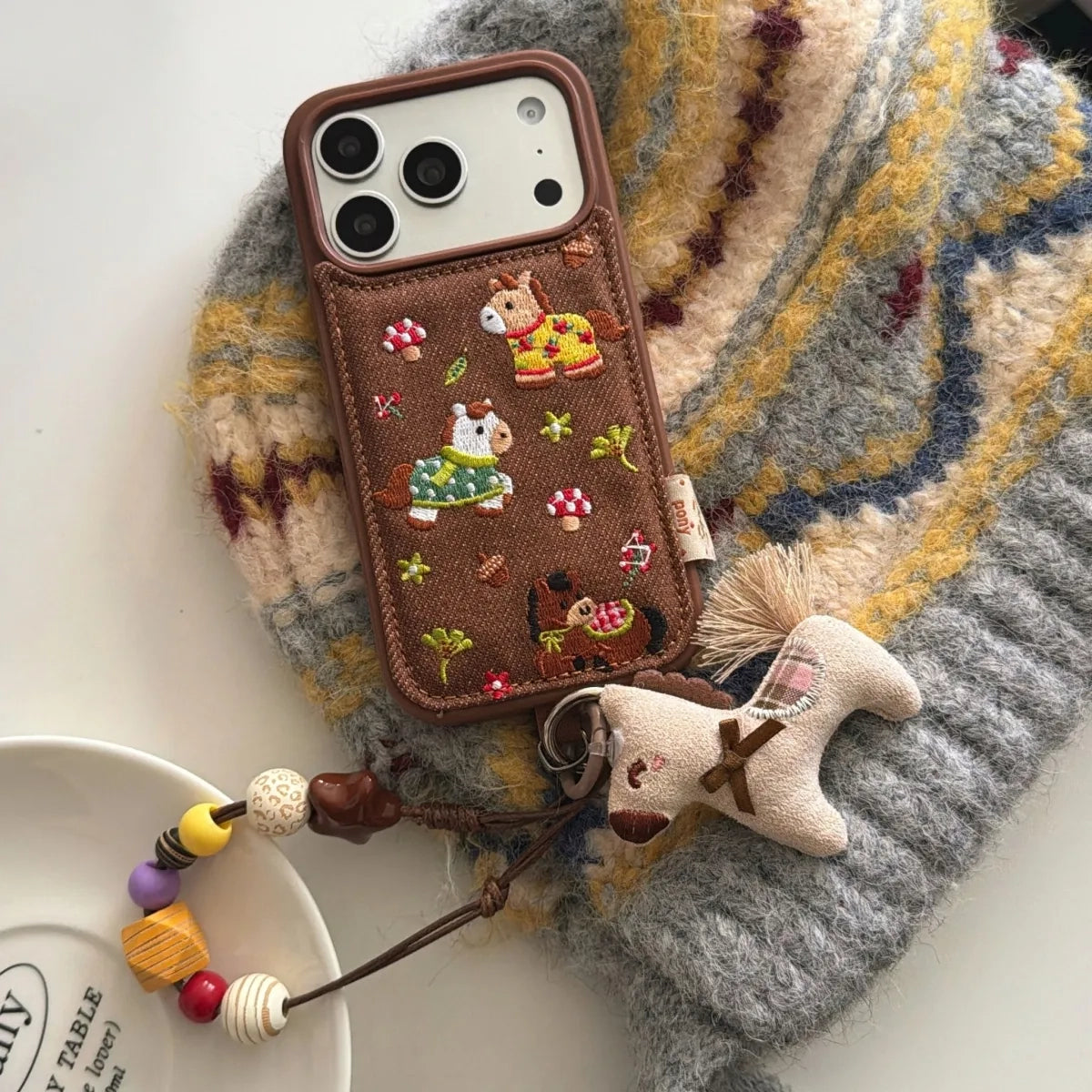 Embossed embroidered pony phone case by TRLab Shop featuring colorful pony design on durable fabric.
