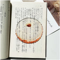 Translucent fruit-shaped acrylic bookmark with colorful fruit illustrations, ideal for marking pages in books.