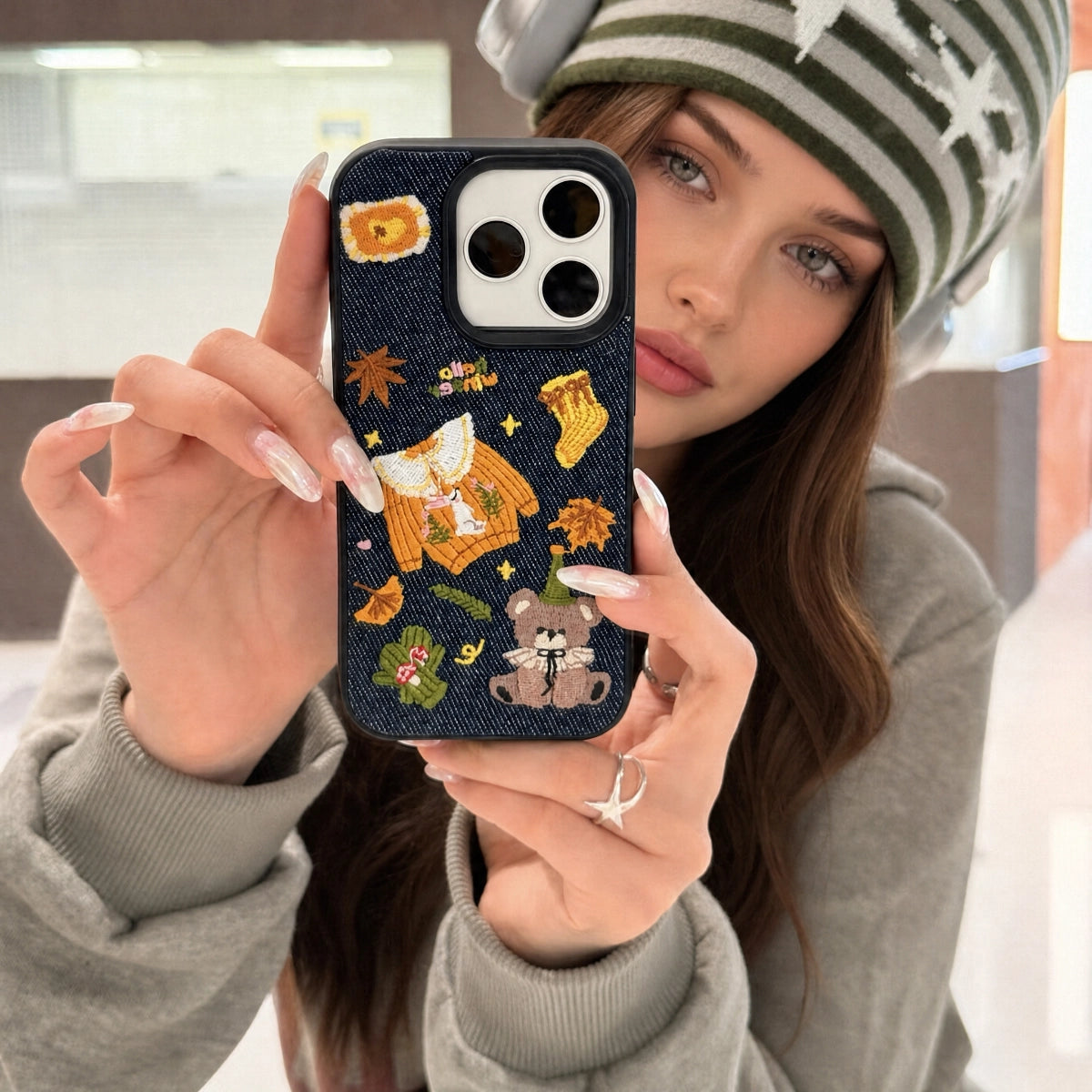 Warm autumn embroidered phone case by TRLab Shop featuring detailed leaf and floral embroidery on a soft fabric background.