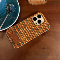 Striped corduroy phone case in beige and brown with a textured fabric surface, designed for iPhone models.