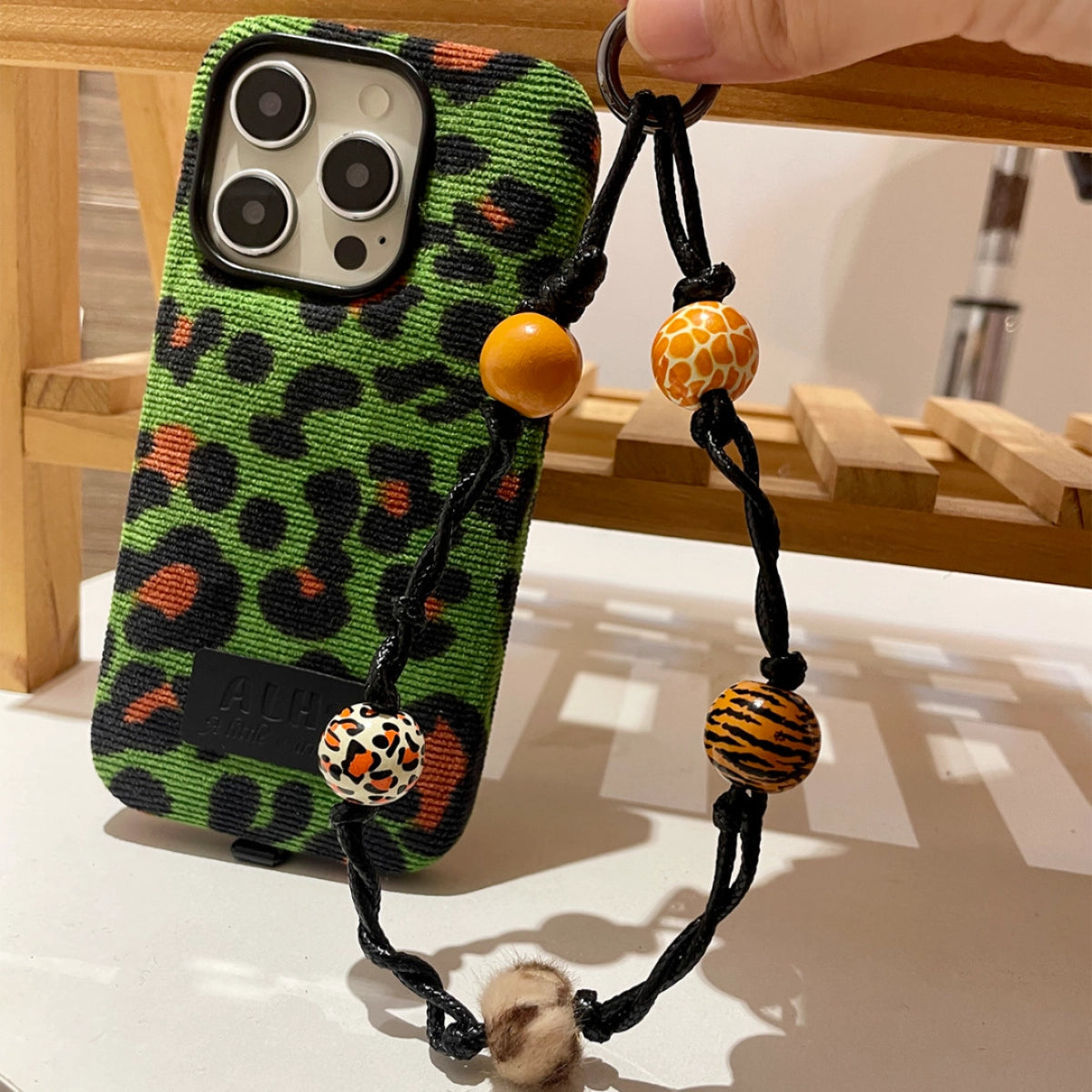 Green leopard print corduroy phone case with TRLab Shop branding, featuring a textured fabric pattern and snug fit for smartphones.