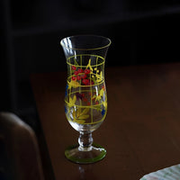 Hand-painted glass vase with colorful floral designs, showcasing intricate artwork and smooth glass surface.