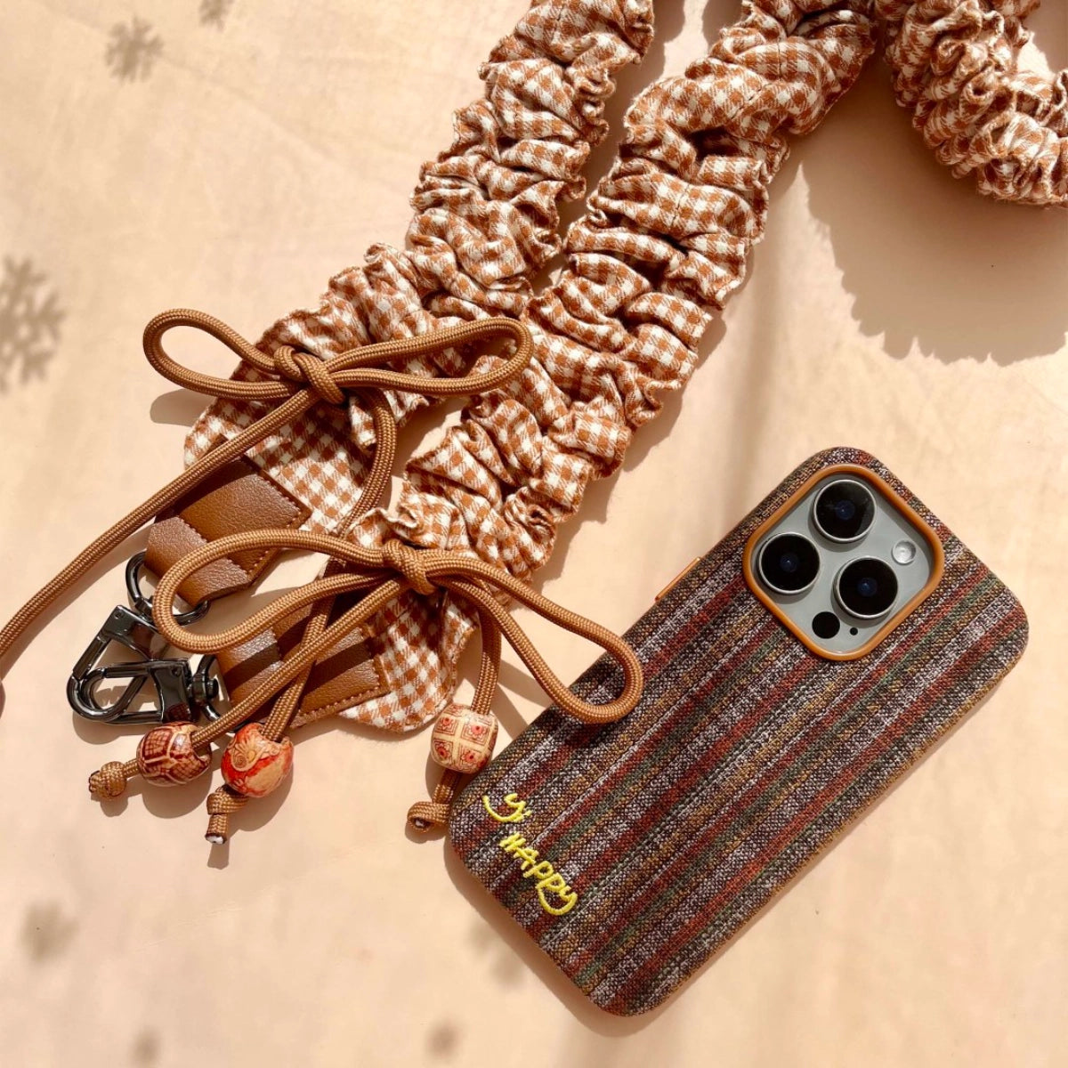 Embroidered Happy Letters design on TRLab Shop phone case in black with colorful stitched lettering for iPhone and Android models.