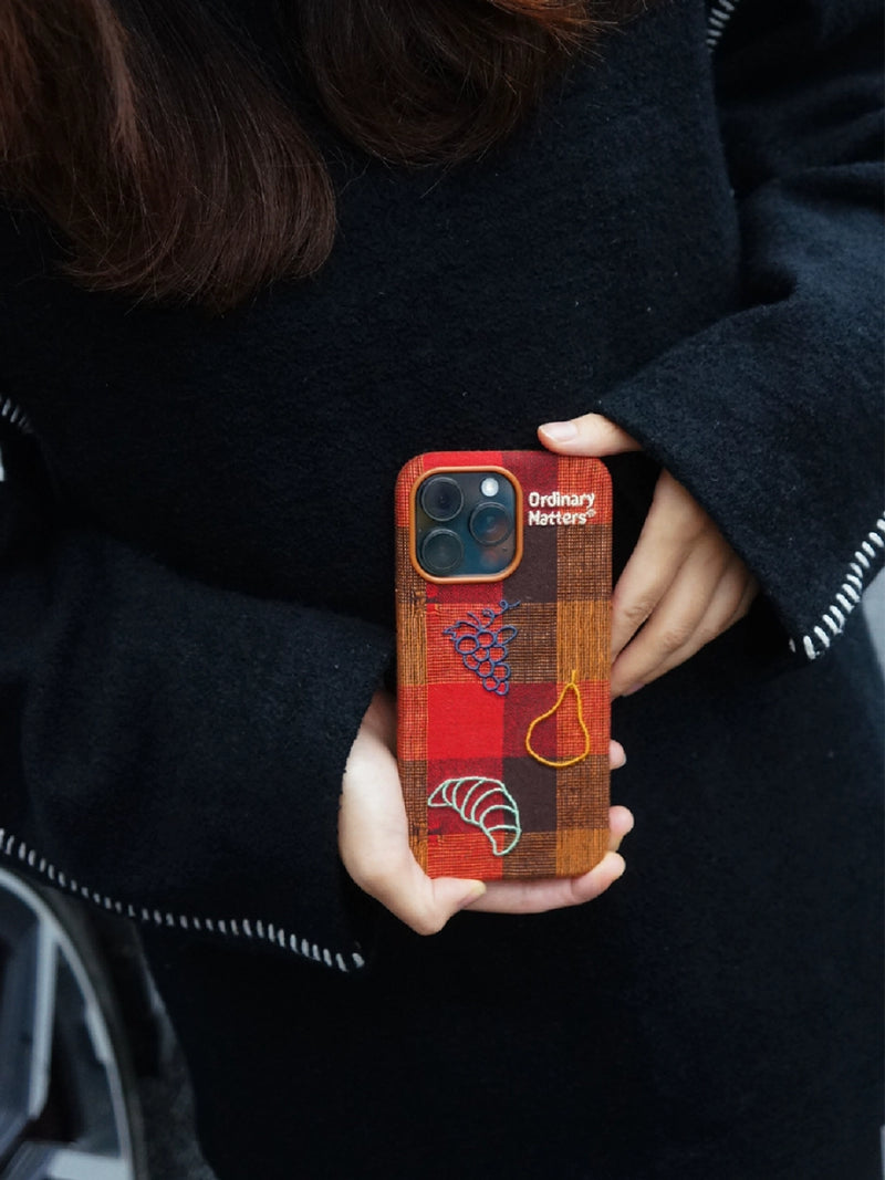 Fruit and bread embroidered phone case with colorful fruit and bread designs on a durable fabric background.
