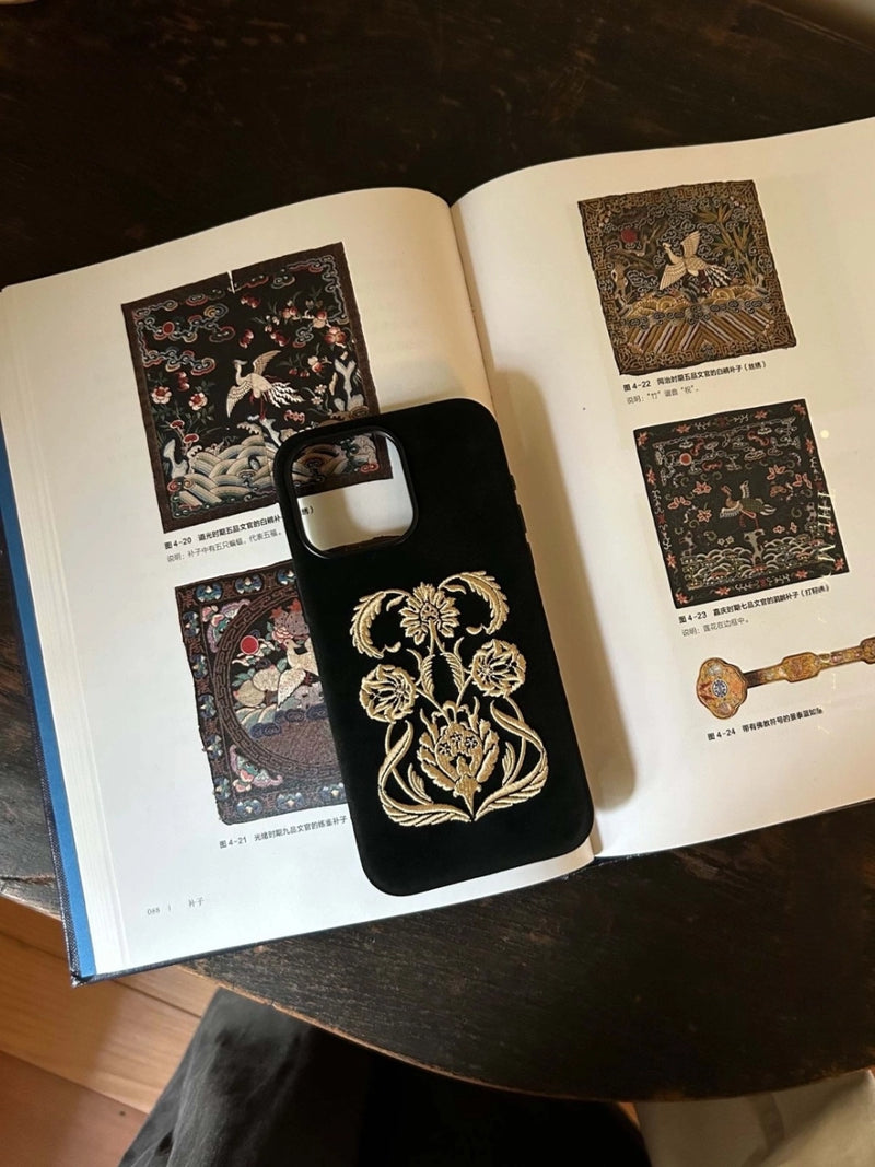 Black Shamanic embroidered phone case with intricate tribal patterns, designed for durable protection and stylish appearance.