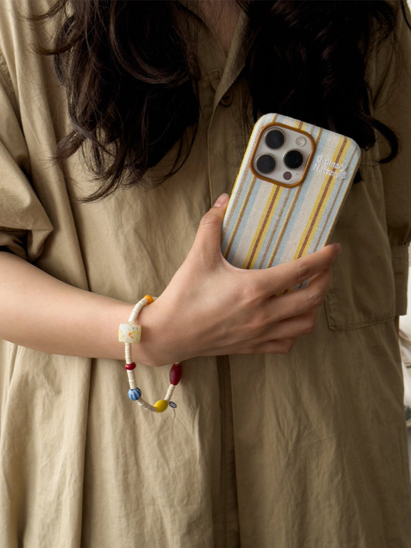 Striped fabric phone case by TRLab Shop showing a close-up of the colorful striped design and textured fabric surface.